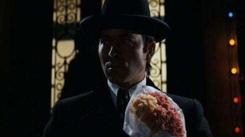 A baker bearing flowers