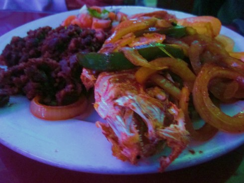 A snapper drowning in onions.